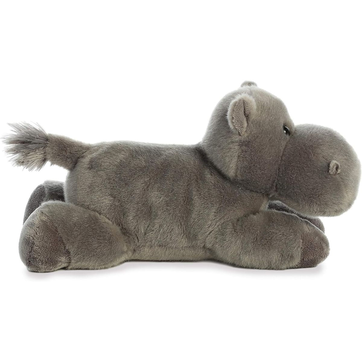 Side profile view of the gray hippo stuffed animal showing its lounging posture, short legs, and small tufted tail.