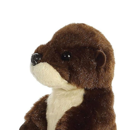 Close-up view of the river otter's face highlighting its sweet black nose, dark eyes, and soft cream-colored muzzle.