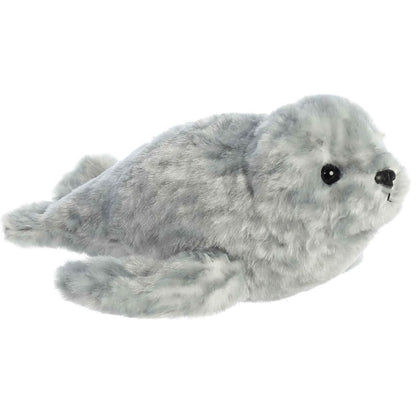Angled front view of the 8-inch Aurora Mini Flopsie Harbor Seal stuffed animal resting on its tummy, showing its mottled grey plush coat and front flippers.