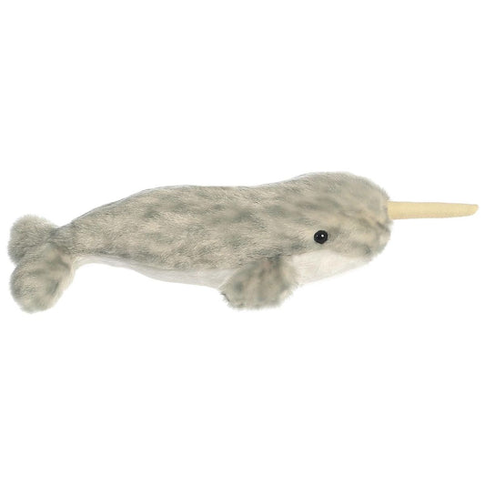 Side view of the Aurora Mini Flopsie Narwhal 8-inch plush resting on its belly, featuring mottled grey fur and a soft golden tusk.