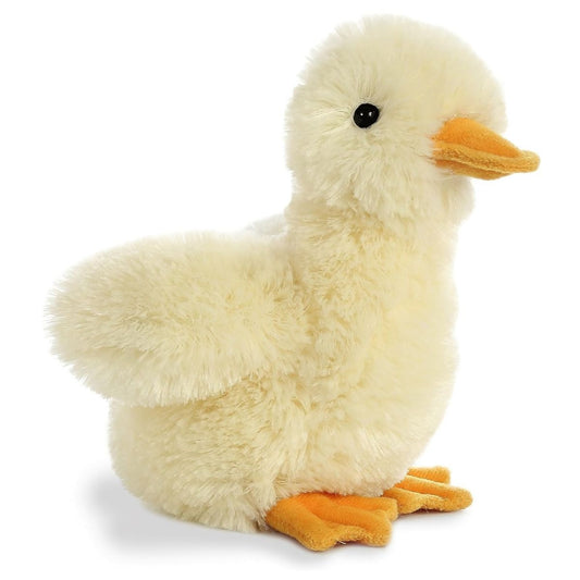 Angled side view of the Aurora Flopsie 8-inch Duckling plush sitting, showing its extra fluffy pastel yellow fur, orange beak, and orange webbed feet.