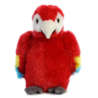 Straight front view of the Scarlet Macaw plush resting flat on its belly, showing its white face and curved beak.