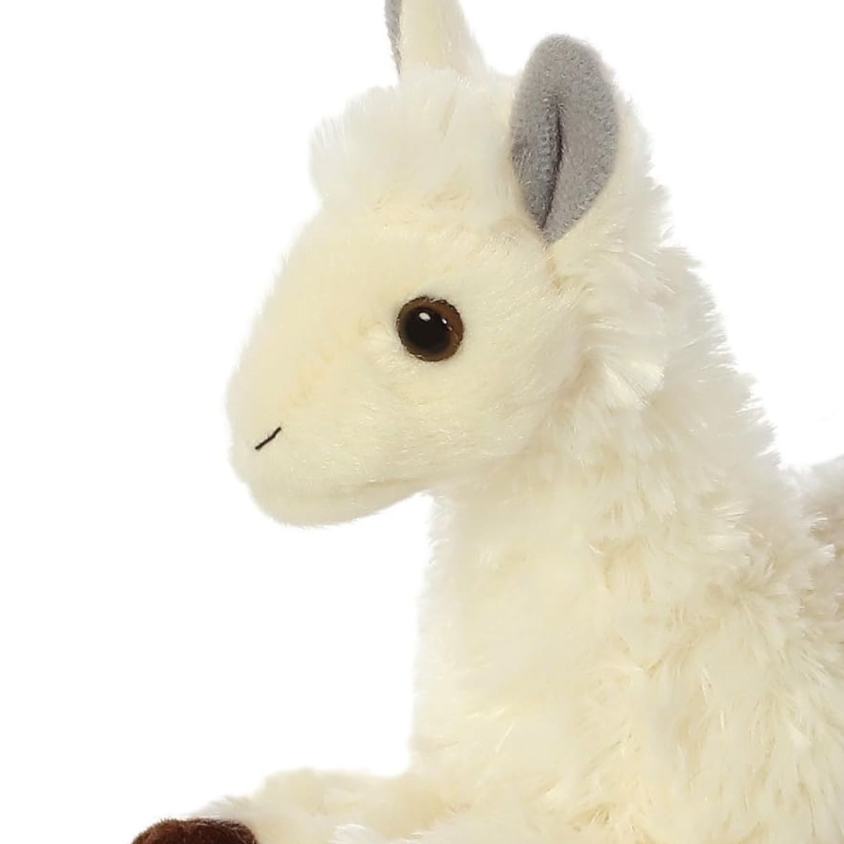 Close-up view of the llama's face highlighting its sweet dark eyes, cream muzzle, and soft grey ears.