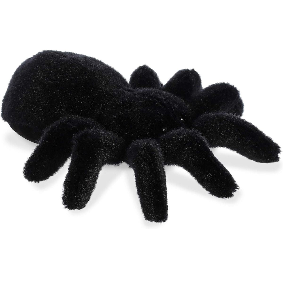 Angled view of the Aurora Mini Flopsie 8-inch Tod the Tarantula plush resting on its belly, showing its solid black body and eight legs.