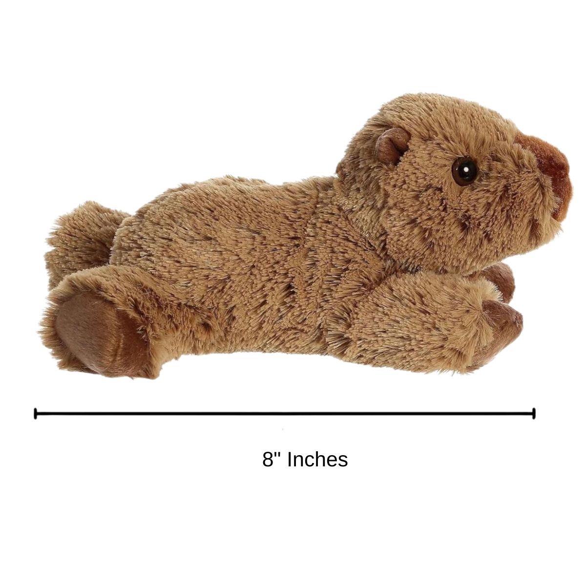 The Aurora 8-inch Charlie Capybara plush toy laying on a surface showing its compact size.