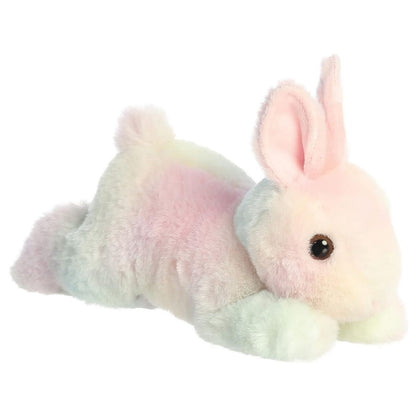 Angled side view of the Aurora Flopsie 8-inch Spring Time Pastel Bunny plush laying down, showing its colorful tie-dye fur and pink inner ears.