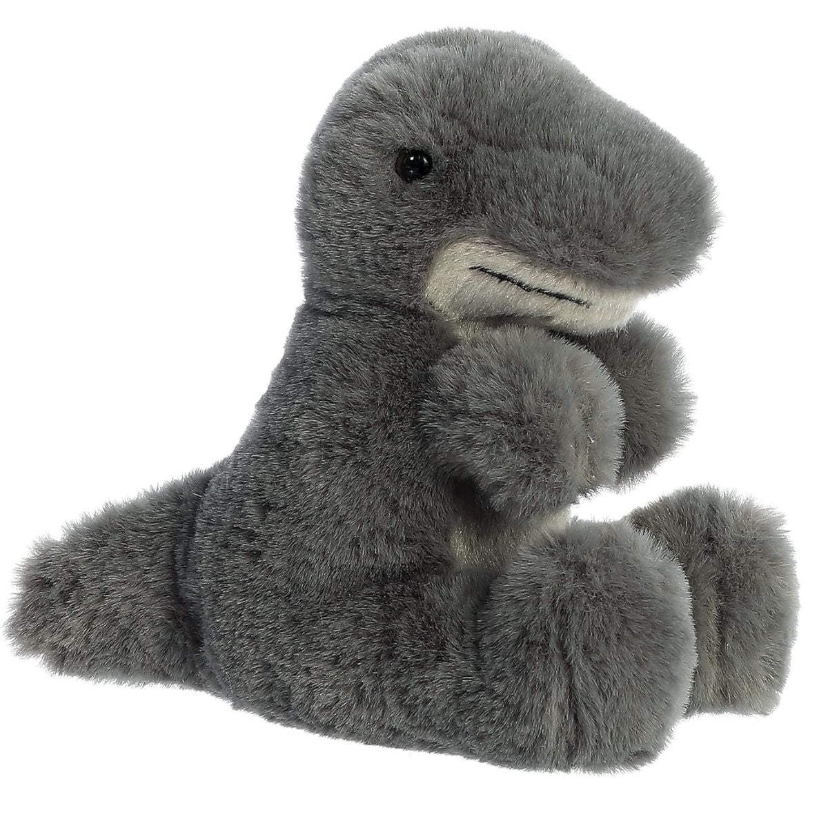 Angled side view of the 8-inch Aurora Mini Flopsie T-Rex plush featuring soft grey fur, a lighter underbelly, and tiny dinosaur arms.