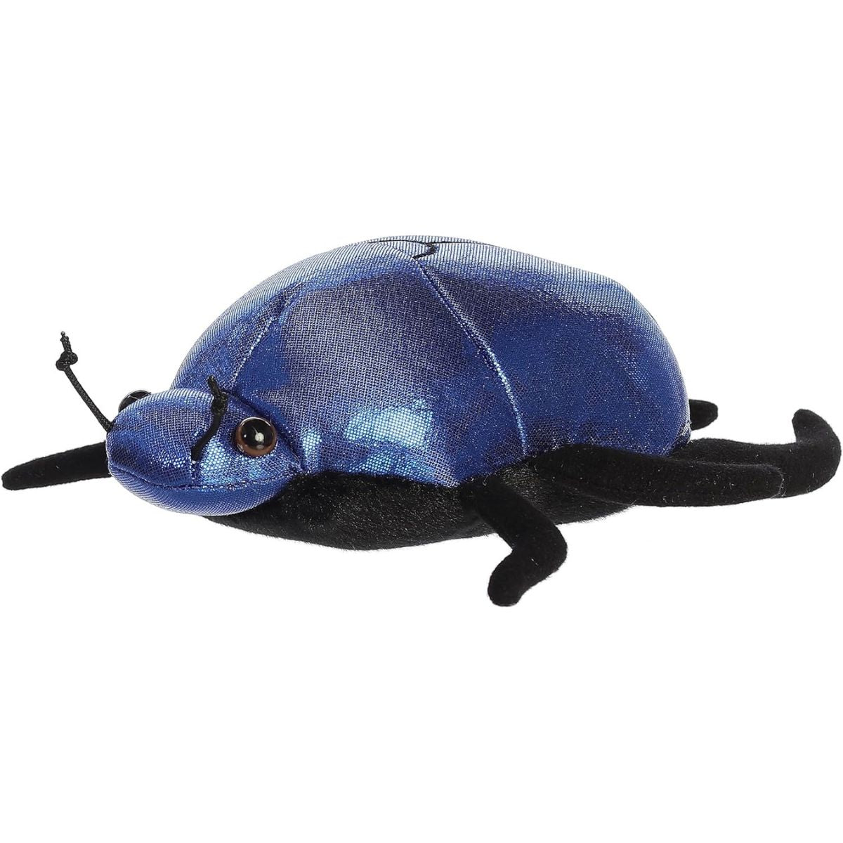 Another angled side view of the metallic blue scarab beetle resting flat on its black plush legs.