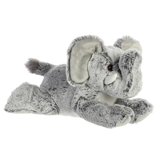 Angled front view of the Aurora Flopsie Leroy the Elephant 12-inch plush resting on its belly, featuring textured gray fur and a raised trunk.
