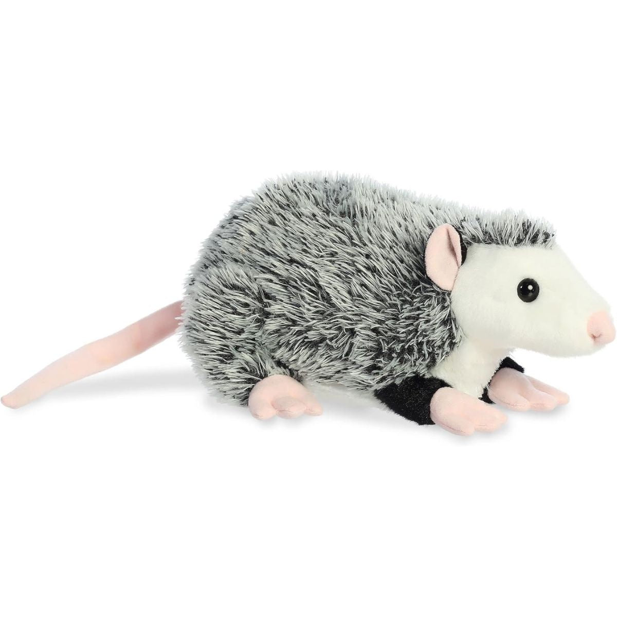 Angled side view of the Aurora Flopsie Ozzie the Opossum 12-inch plush featuring grey salt-and-pepper fur and a long pink tail.