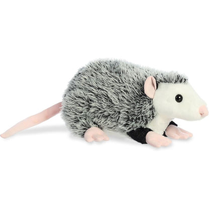 Angled side view of the Aurora Flopsie Ozzie the Opossum 12-inch plush featuring grey salt-and-pepper fur and a long pink tail.