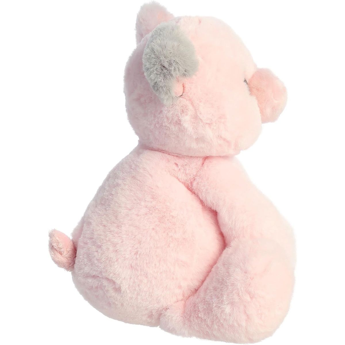 Side view of the pink piglet stuffed animal highlighting its sitting posture and soft plush profile.