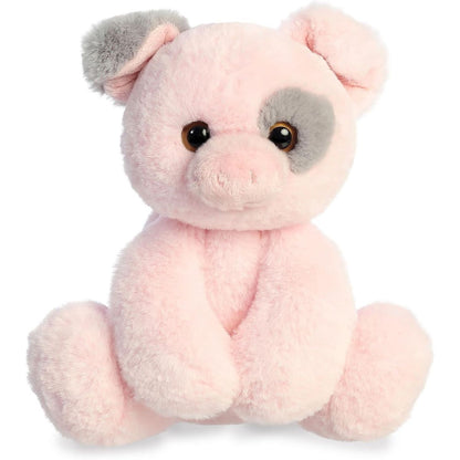 Straight-on front view of the Aurora Flopsie Parsley Piglet 12-inch plush sitting upright, featuring pink fur with a grey eye patch.