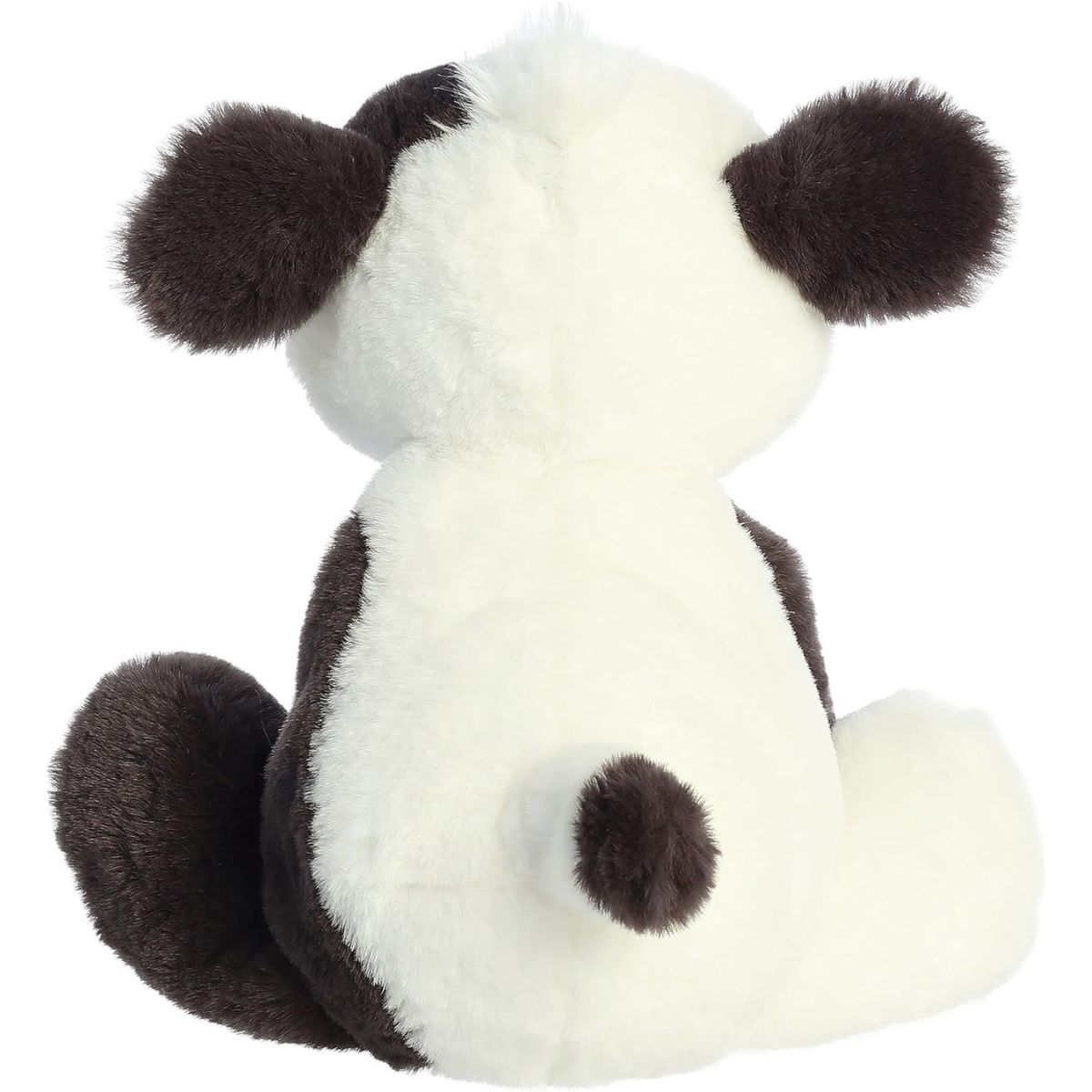 Rear view of the cow plush highlighting its spotted back and small black-tipped tail.