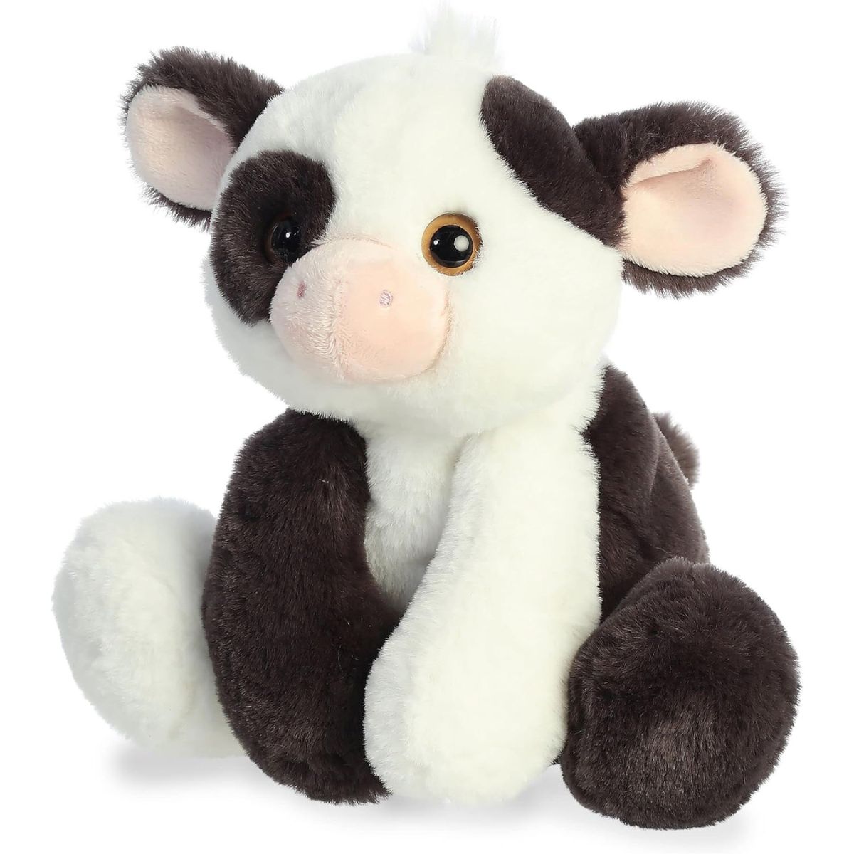 Angled front view of the cow highlighting its sweet pink muzzle and floppy black ears.