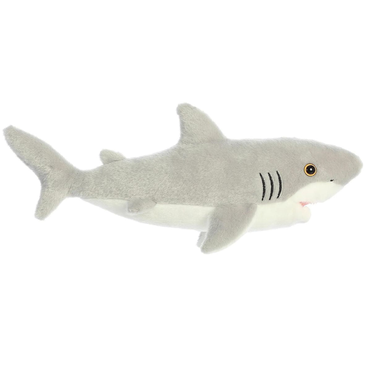 Side profile view of the gray shark plush showing its lounging posture, embroidered black gills, and tail fin.