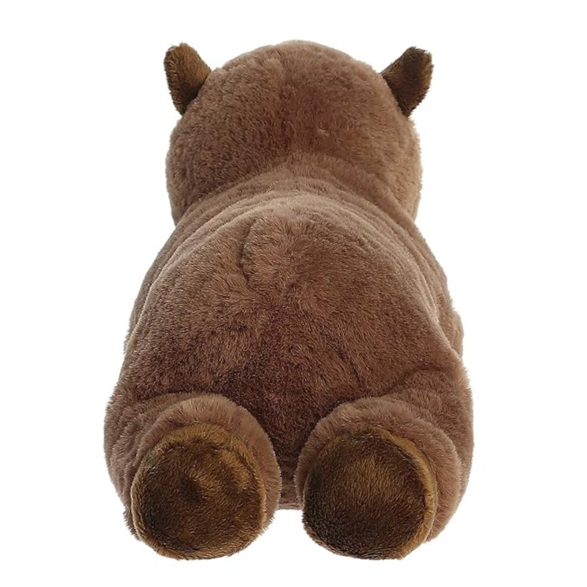 Back view of the resting capybara stuffed animal showing its soft brown plush body and dark brown hind paws.