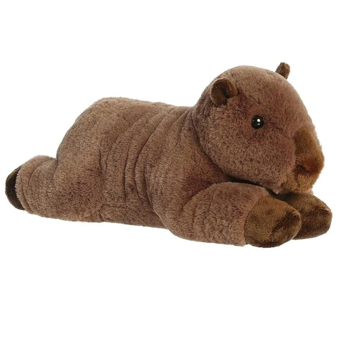 Angled front view of the Aurora Flopsie Capybara 12-inch stuffed animal resting on its belly, featuring soft brown fur and a rounded snout.