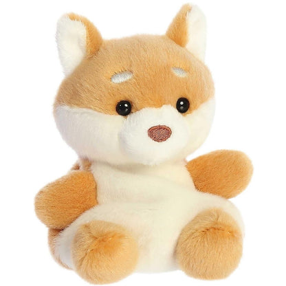 Aurora 5-inch Palm Pals Keiko Shiba Inu plush toy sitting at an angle showing its golden-tan fur, white muzzle and chest, alert ears, and small white eyebrow spots.