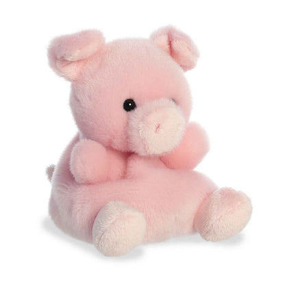 Aurora 5-inch Palm Pals Wizard Pig plush toy sitting at an angle showing its soft pastel pink fur, prominent snout, and folded floppy ears.