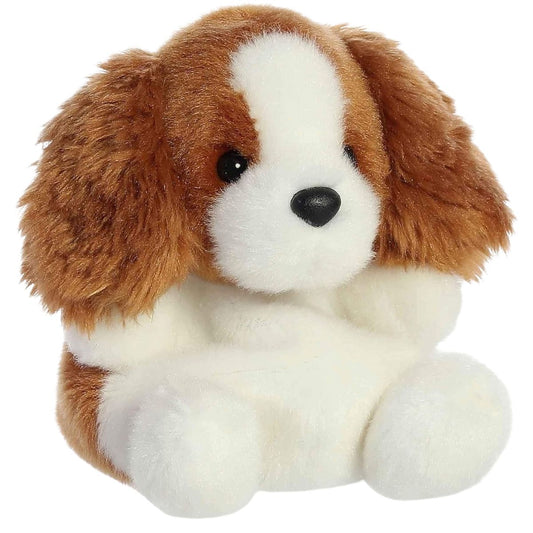 Aurora 5-inch Palm Pals Lady Spaniel plush toy showing its chestnut-brown and white puppy body, shaggy floppy ears, black button nose, and sitting posture.