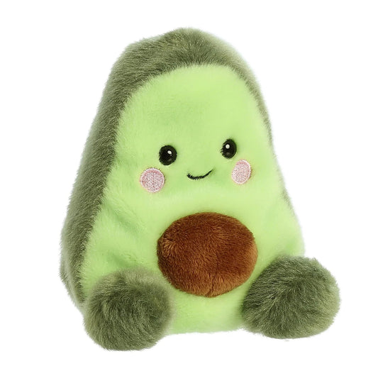Angled view of the Aurora Palm Pals 5-inch Airy Avocado plush sitting upright, showing its light green center, brown pit, and sweet face.
