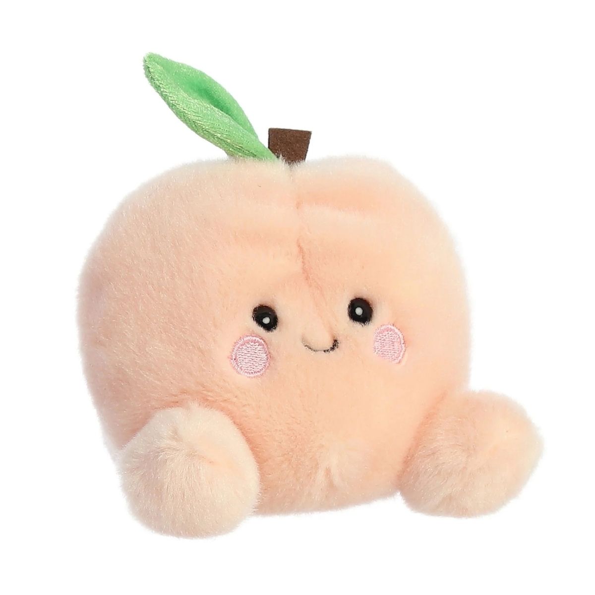 Aurora 5-inch Palm Pals Mellow Peach plush toy showing its soft pastel-orange round body with a central indentation, a brown top stem with a green leaf, and a sweet smiling face with blushing cheeks.