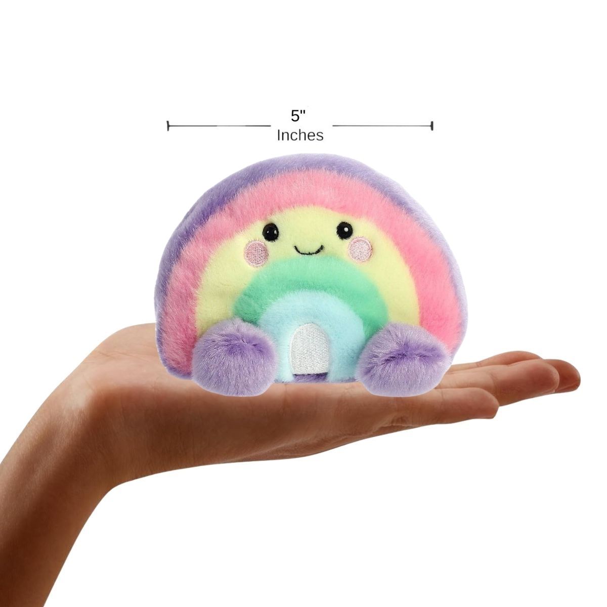 Lifestyle sizing graphic showing the 5-inch Aurora Palm Pals Vivi Rainbow plush sitting perfectly in the palm of a person's outstretched hand.