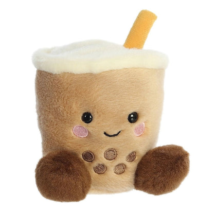 Angled view of the Aurora Palm Pals 5-inch Milky Tea Boba plush sitting upright, showing its tan cup body, fluffy white top, straw, and boba pearls.