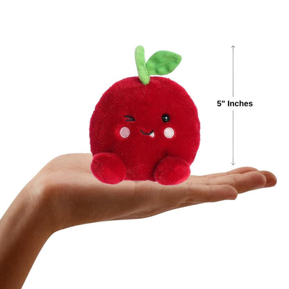 The 5-inch Aurora Palm Pals Cordial Cherry resting comfortably in the palm of a person's hand.