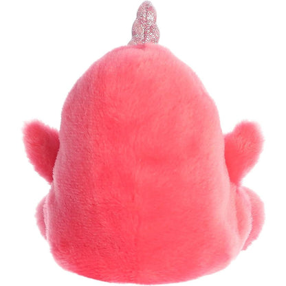 Rear view of the Aurora narwhal stuffed toy displaying its smooth, solid bright pink plush backing and extended flippers.