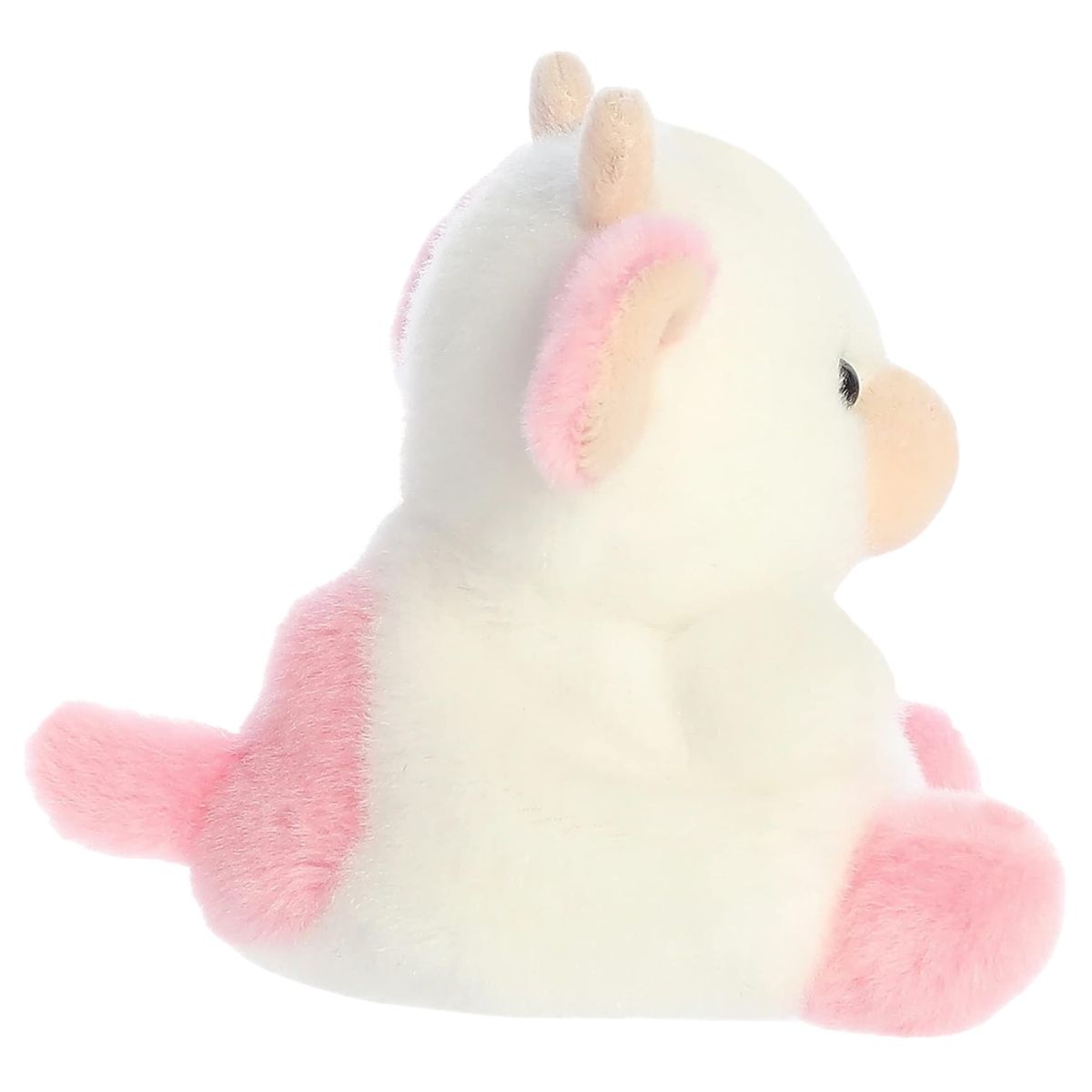 Side profile view of the Palm Pals Strawberry Cow plush highlighting its perfectly squishy round body, pink ear, and pink hooves.
