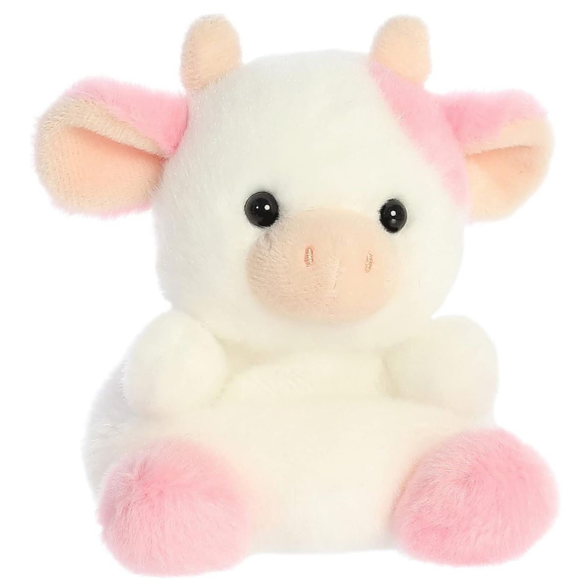 Angled view of the Aurora Palm Pals 5-inch Belle Strawberry Cow plush sitting upright, showing its white fur, pink spots, and pink snout.