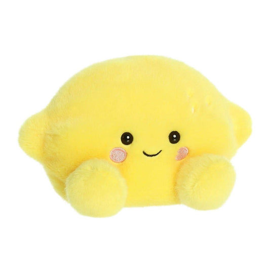 Aurora 5-inch Palm Pals Yuzu Lemon plush toy showing its vibrant yellow oval body, small pointed citrus ends, and a sweet smiling face with blushing cheeks.