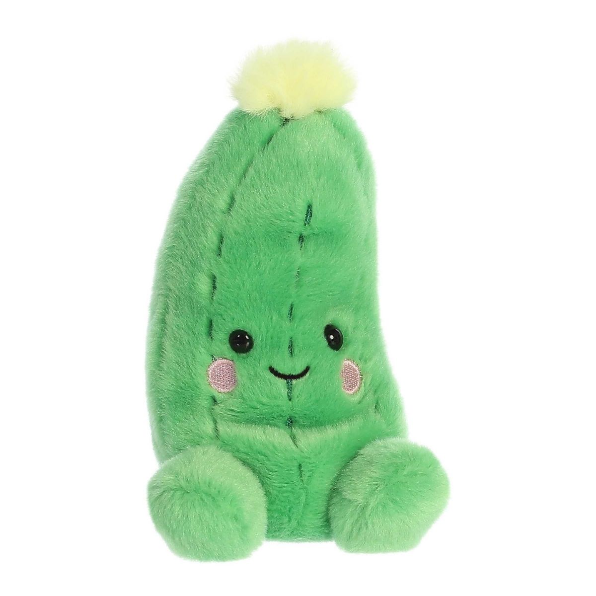 Aurora 5-inch Palm Pals Dillian Cucumber plush toy showing its elongated green body, vertical ridge stitching, small yellow top flower bloom, and a happy smiling face with rosy cheeks.