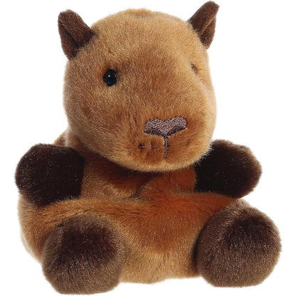 Aurora 5-inch Palm Pals Sid Capybara plush toy sitting at an angle showing its golden-brown fur, chunky blunt muzzle, dark brown ears, and dark brown paws.