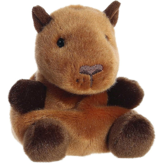 Aurora 5-inch Palm Pals Sid Capybara plush toy sitting at an angle showing its golden-brown fur, chunky blunt muzzle, dark brown ears, and dark brown paws.