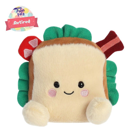 Front view thumbnail of the cute Tomas BLT plush sitting straight with a "Retired" tag graphic overlay, highlighting its dark safety eyes, small stitched grin, and cream plush feet.