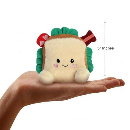 The miniature Tomas BLT plush sitting balanced in an open human hand under a 5-inch height graphic indicator.