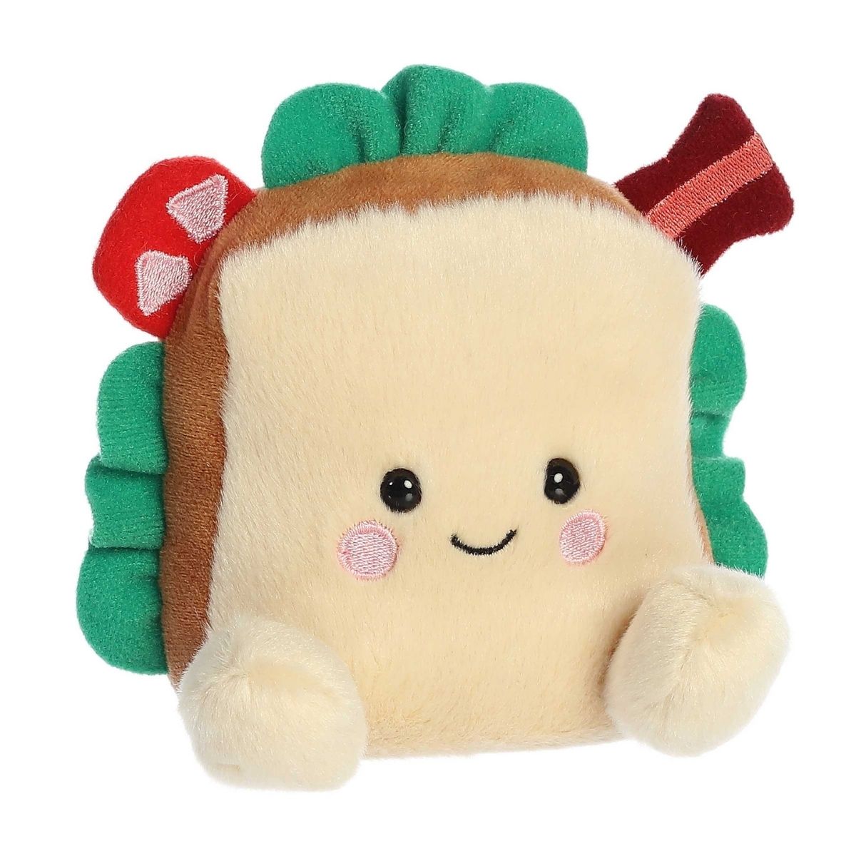 Aurora 5-inch Palm Pals Tomas BLT sandwich plush toy showing its cream bread face, green lettuce edges, red tomato slices, a wavy bacon strip sticking out the top corner, and a happy smiling face with rosy cheeks.
