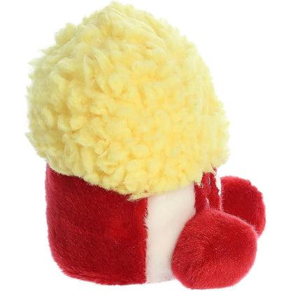 Side profile view of the Palm Pals Popcorn plush highlighting its perfectly squishy body, red and white stripes, and textured yellow top.