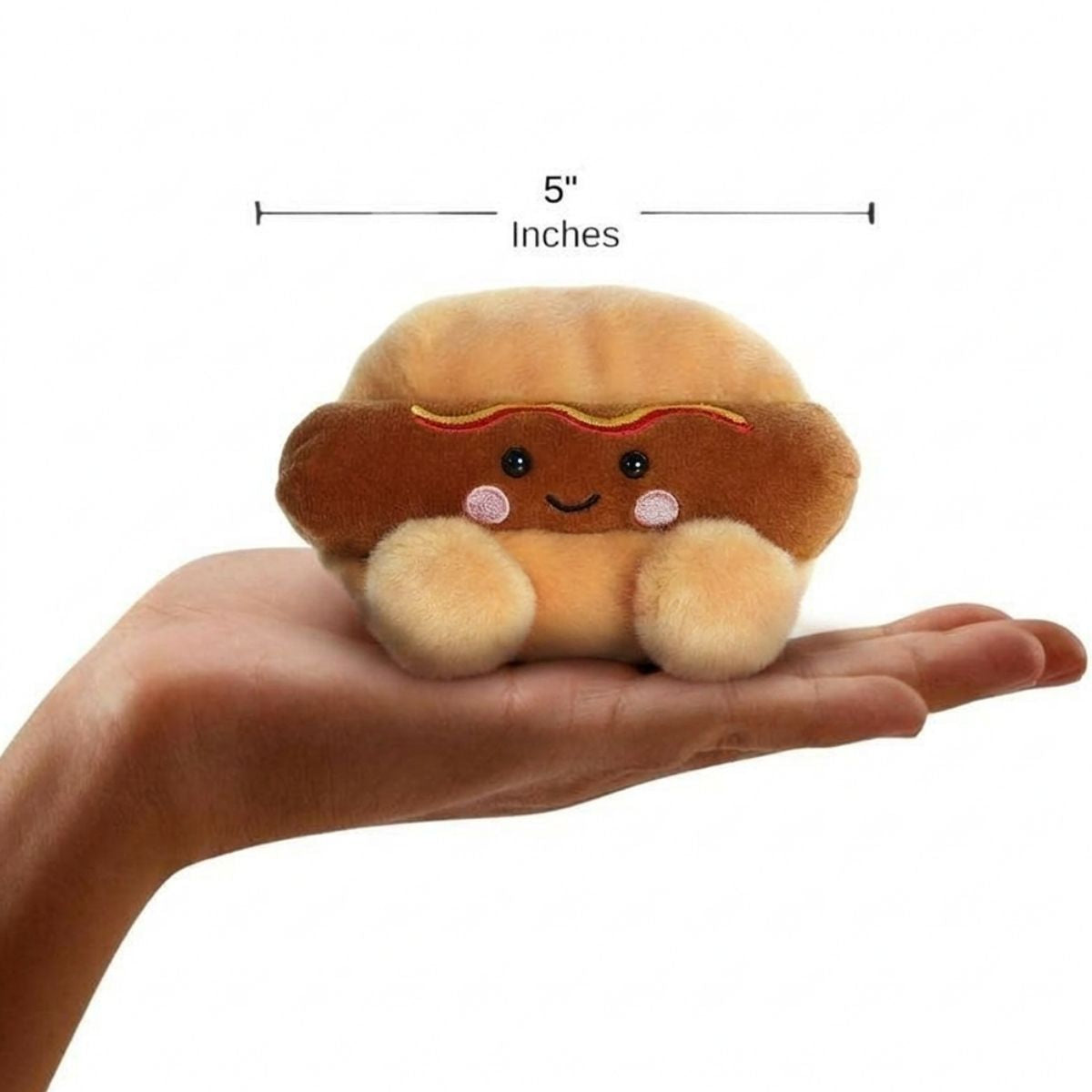 The miniature Colson Hot Dog plush sitting balanced in an open human hand under a 5-inch height graphic indicator.