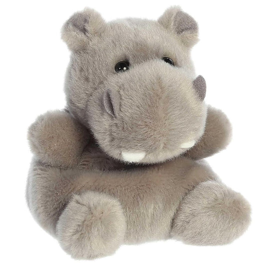 Angled view of the Aurora Palm Pals 5-inch Hunk Hippo plush sitting upright, showing its soft taupe-grey fur, large snout, and two small white teeth.