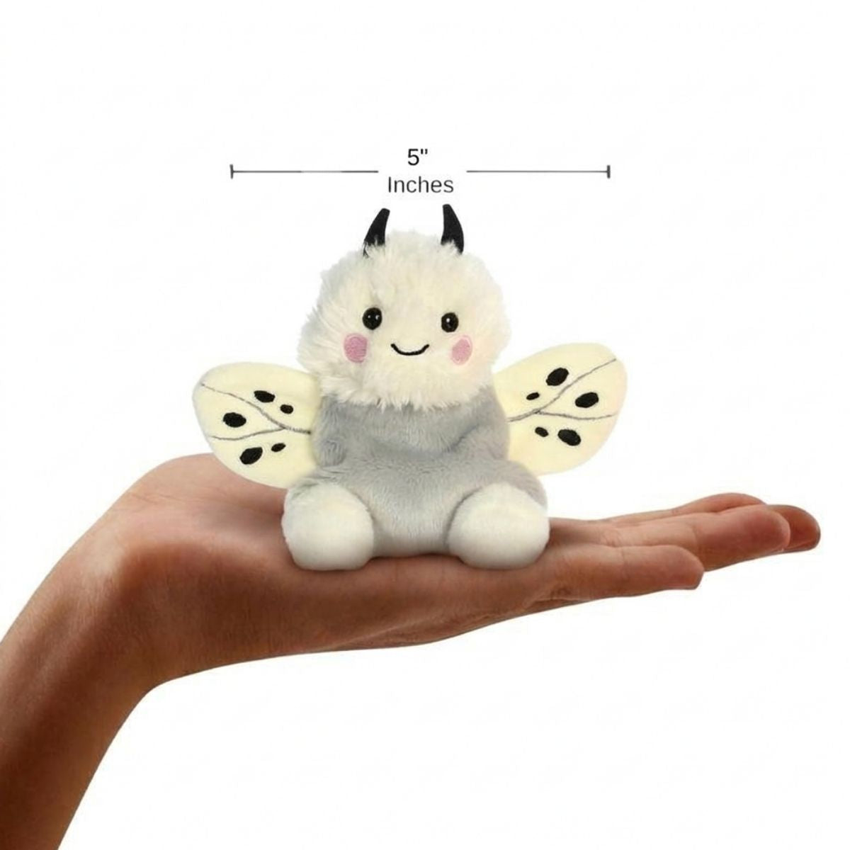The miniature Astra Moth plush sitting balanced in an open human hand under a 5-inch height graphic indicator.