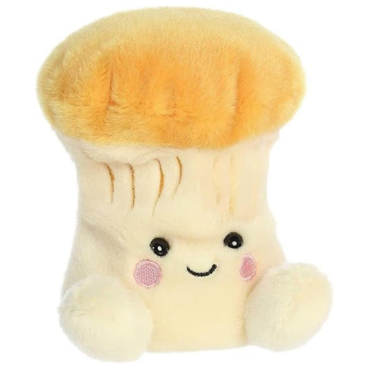 Aurora 5-inch Palm Pals Jackie Chanterelle Mushroom plush toy showing its soft cream stalk body, flared golden-orange cap, stitched under-cap ridges, and happy smiling face.