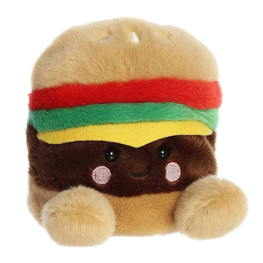 Angled view of the Aurora Palm Pals 5-inch Charles Cheeseburger plush sitting upright, showing its layered bun, ketchup, lettuce, cheese, and patty with a sweet face.