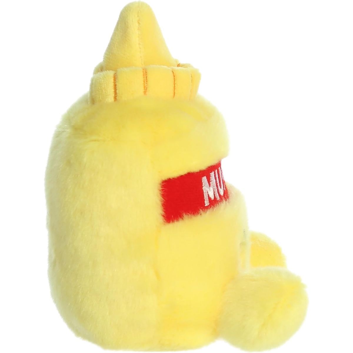 Side profile view of the Palm Pals Mustard plush highlighting its squishy bean-weighted body, red label wrapping around the side, and pointed yellow nozzle top.