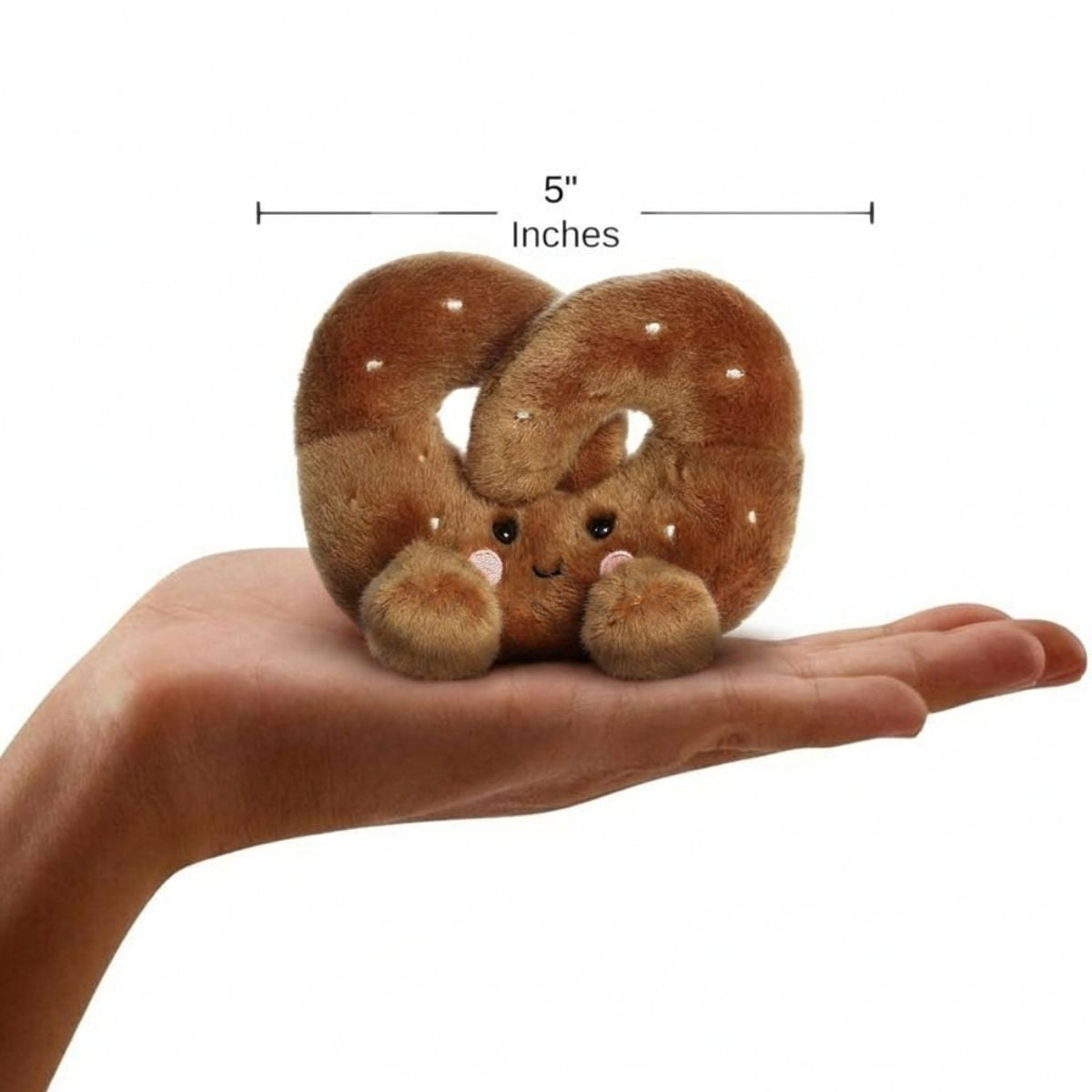 The miniature Twist Pretzel plush sitting balanced in an open human hand under a 5-inch height graphic indicator.