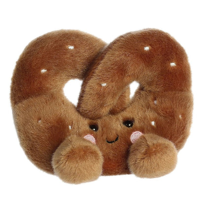 Aurora 5-inch Palm Pals Twist Pretzel plush toy showing its golden-brown knotted body, white embroidered salt crystals, and a sweet smiling face with blushing cheeks.