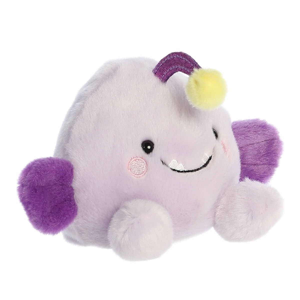 Aurora 5-inch Palm Pals Blinky Angler Fish plush toy showing its pale purple body, dark purple side fins, top head stalk with a yellow bulb, and a smiling face with tiny stitched teeth.